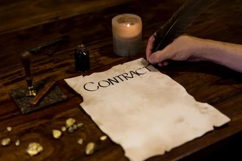 Medieval looking man writes a contract Fotos Stock