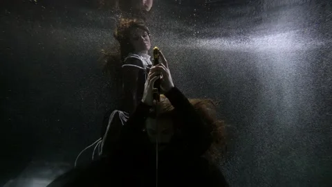 Medieval magic underwater, man with sword and mysterious lady with pearls Stock Footage 167375864