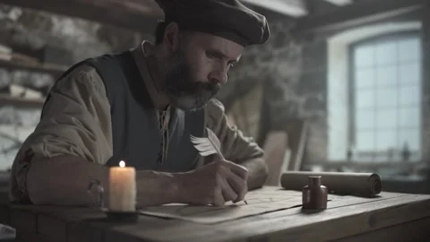 Medieval master drawing a flying machine design with a quill pen on paper Stock Footage 339631040