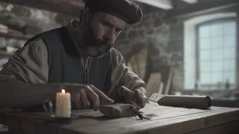Medieval master wetting a whetstone surface and sharpening a penknife blade 스톡 동영상 339631329