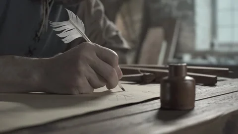 Medieval master writing notes below a geometric sketch on parchment paper Stock Footage 340079974
