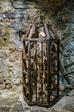 Medieval Metal cage with skeleton for torture Stock Photos