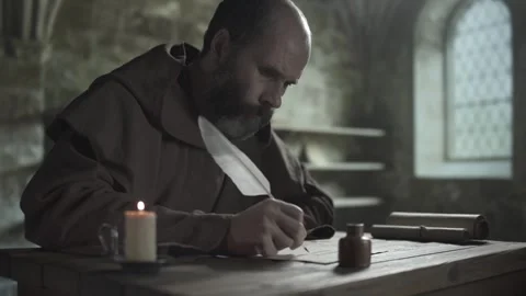 Medieval monk writing calligraphy with a long white feather quill, medium shot 스톡 동영상 339631020