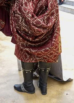 Medieval reenactor in rich red and gold brocade cloak with black leather bo.. Stock Photos