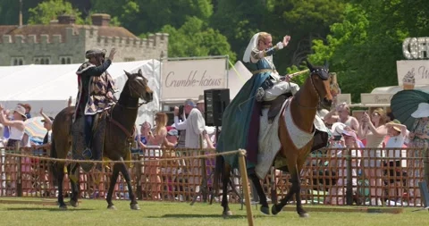Medieval riders salute crowd during Queen's Joust parade Video stock 338419196