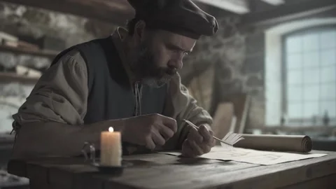 A medieval scholar sharpening a quill pen and testing the nib with a thumb Video stock 340322693