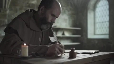 Medieval scribe copying text from liturgical pages with goose quill, medium shot Video stock 337649165