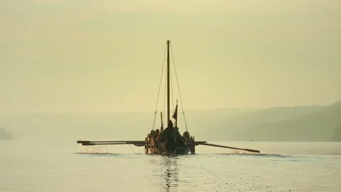 Medieval Ship with Vikings on Board Sails in the Middle of the River Stockbeeldmateriaal 156461165
