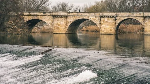 Medieval stone bridge, puente mayor, crossing rio carrion in winter, palencia Stock Footage 124536620