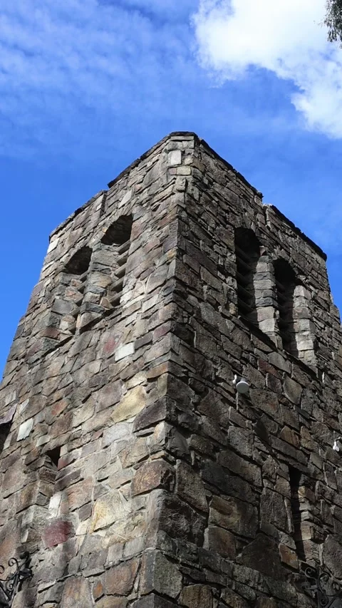 Medieval stone castle tower against a blue sky Stock Footage 341906138