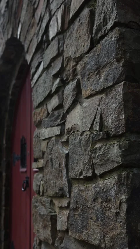 Medieval stone castle wall with red arched door Stock Footage 341913032