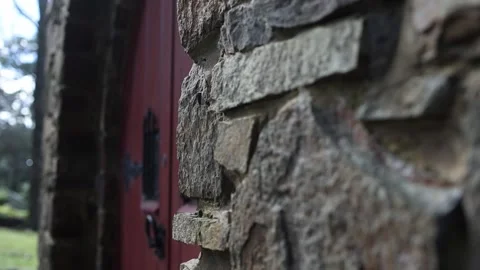 Medieval stone church wall with red door Stock Footage 341908152