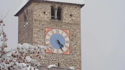 Medieval stone clock tower during a winter snowfall in klosters switzerland Vidéo 330407502