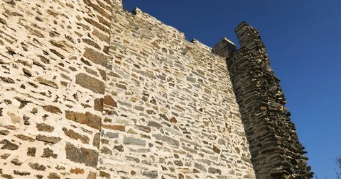 A medieval stone tower with a stone wall and an exterior staircase 動画素材 118535575