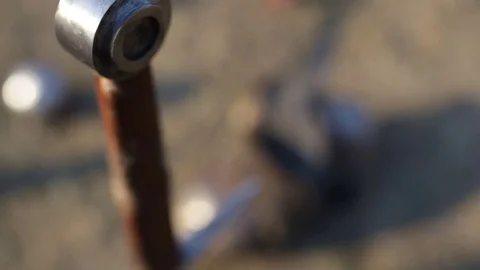 Medieval sword in the ground against the background of armor Stock Footage 79044943