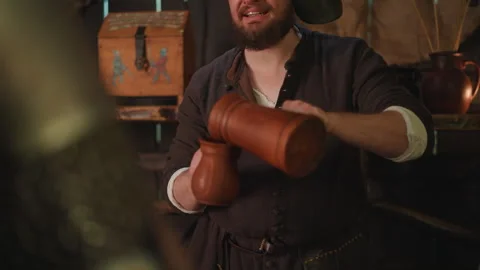 Medieval Tavern Warrior Barkeep Serves Drink to Customer with man drinker Vidéo 347085842