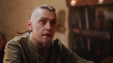 Medieval Tavern Warrior Customer Interacts in Dimly Lit Bar with patron drinker 스톡 동영상 347084005