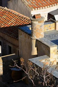 Medieval tiled rooftops with big rounded chimney Stock Photos