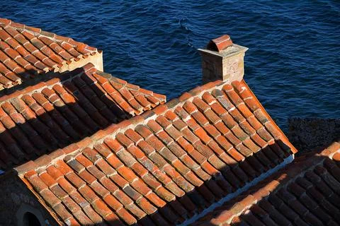 Medieval tiled rooftops with chimneys Stock Photos