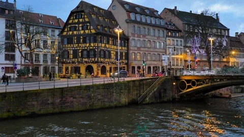 Medieval timber-framed facades next to Strasbourg canal at Christmas sunset Stock Footage 124479844