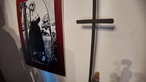 Medieval torture device hanging on a white wall with a security camera Video stock 319709713