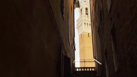 Medieval Tower Peeking Between Buildings Stock Footage 275417834