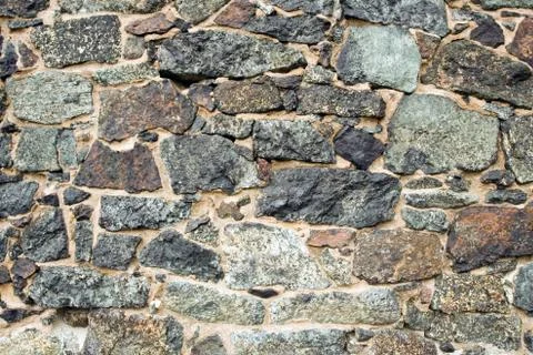 Medieval wall brick texture or background made of stones and rocks. Part of w Stock Photos