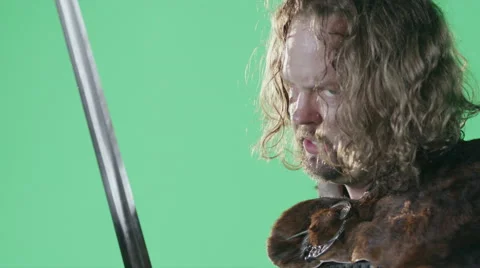 A Medieval Warrior Prepares For A Battle In Front Of A Green Screen. Stock Footage