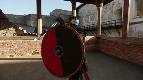 Medieval warrior swinging a sword while holding a shield Stock Footage 333816281