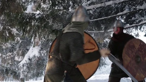 Medieval warriors fighting in a winter forest with swords in armor Stock Footage 70870670