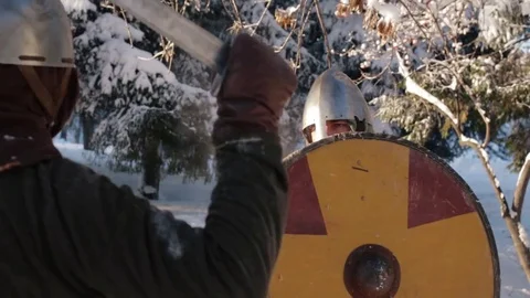 Medieval warriors fighting in a winter forest with swords in armor Stock Footage 70870731