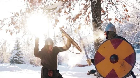 Medieval warriors fighting in a winter forest with swords in armor Stock Footage 70870769