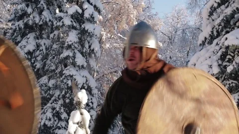 Medieval warriors fighting in a winter forest with swords in armor Stock Footage 70870800