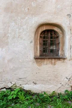 Medieval window  in an old plastered wall Stock Photos