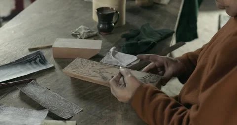 Medieval worker hand paints pattern onto printing block for textile printing #1 Stock Footage 320556131
