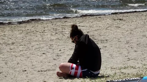 Meditating on the beach Stockbeeldmateriaal 253702799