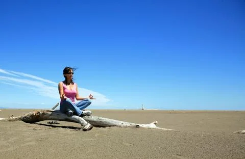 Meditating by the beach Stock Photos