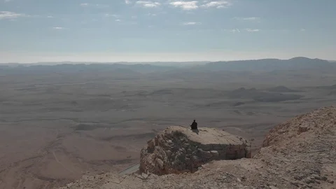 Meditating in front of the Crater Ramon Stock Footage 115344909
