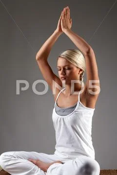 Meditating girl isolated on grey Stock Photos