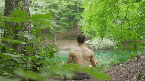 Meditating by the lake. Stock Footage 212286059