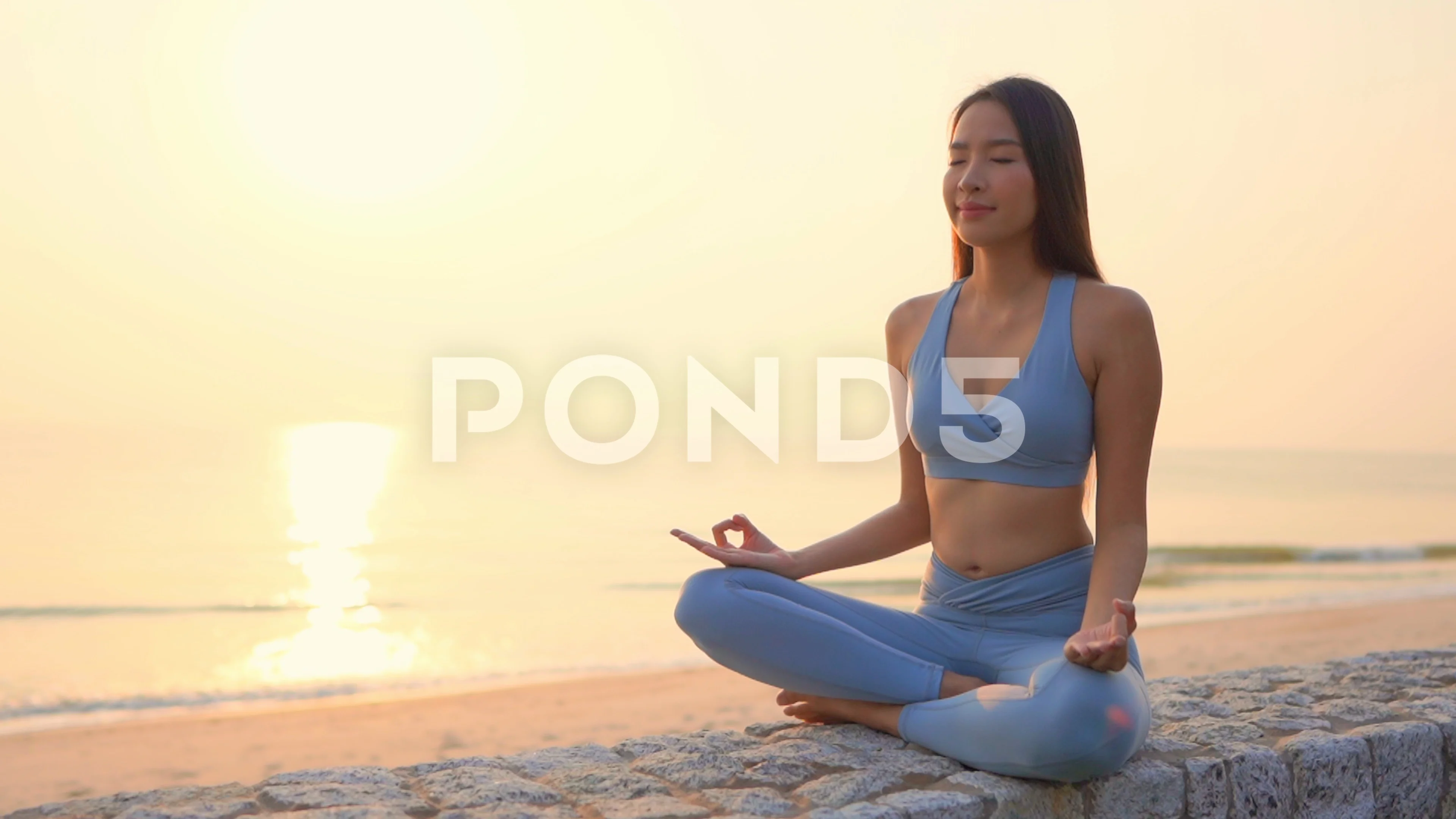 Asian Chinese Woman in Various Yoga Poses at the Beach Stock Image