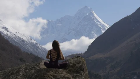 Meditation in front of snow-capped peaks Stock Footage 88624602