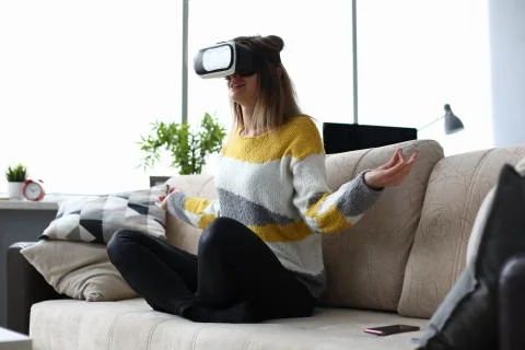 Meditation at home on couch using virtual glasses. Stock Photos
