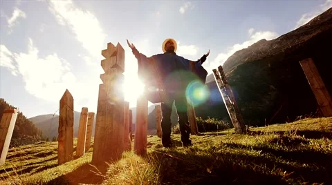 Meditation pose of young man standing in nature scenery at sunset Stock Footage 64802507