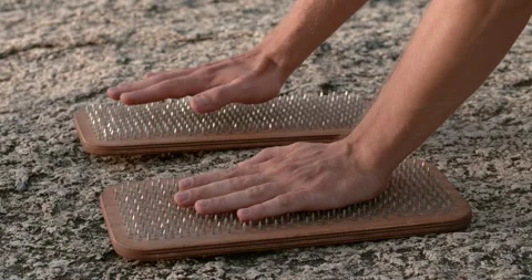 Meditation practice with hands on nail-studded boards close-up Testament to Stock Footage 271008748