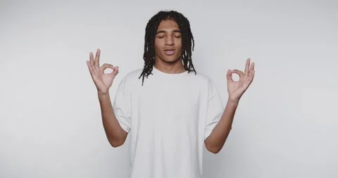 Meditation practice in a studio with a young man focusing on breathing and .. Stock Footage 328248577