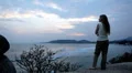 A meditative and romantic blonde girl relaxing waching the sea HD Footage
