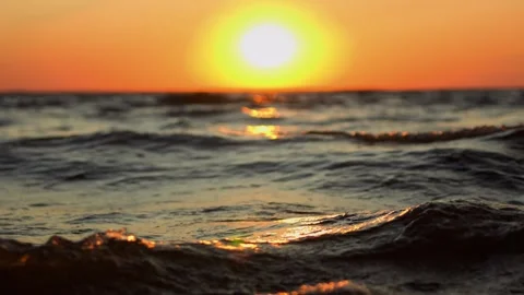 Meditative close-up slow motion splashing waves at sunset or sunrise Stock Footage 246958435