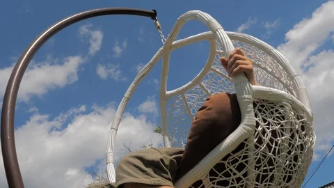 Meditative mood while sitting in comfortable wicker hanging chair outdoor Stock-Footage 116494388