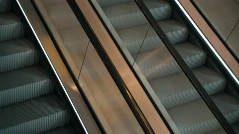 Meditative video of a moving escalator. The steps go up and down. Shiny chrome Stock Footage 194422514